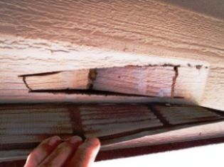 Image of a soffit vent where the piece was not removed after it was cut.